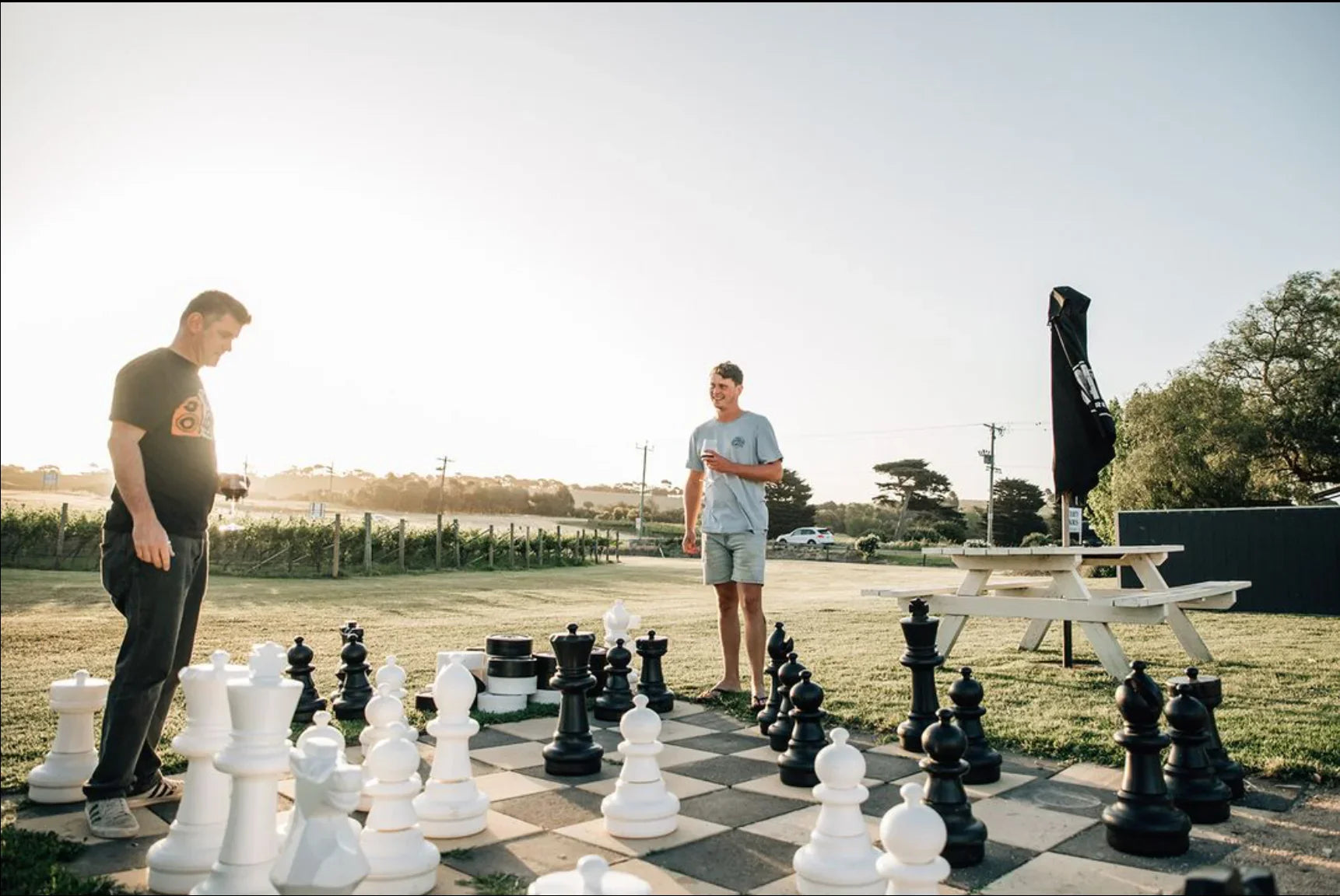 Two men playing giant chess