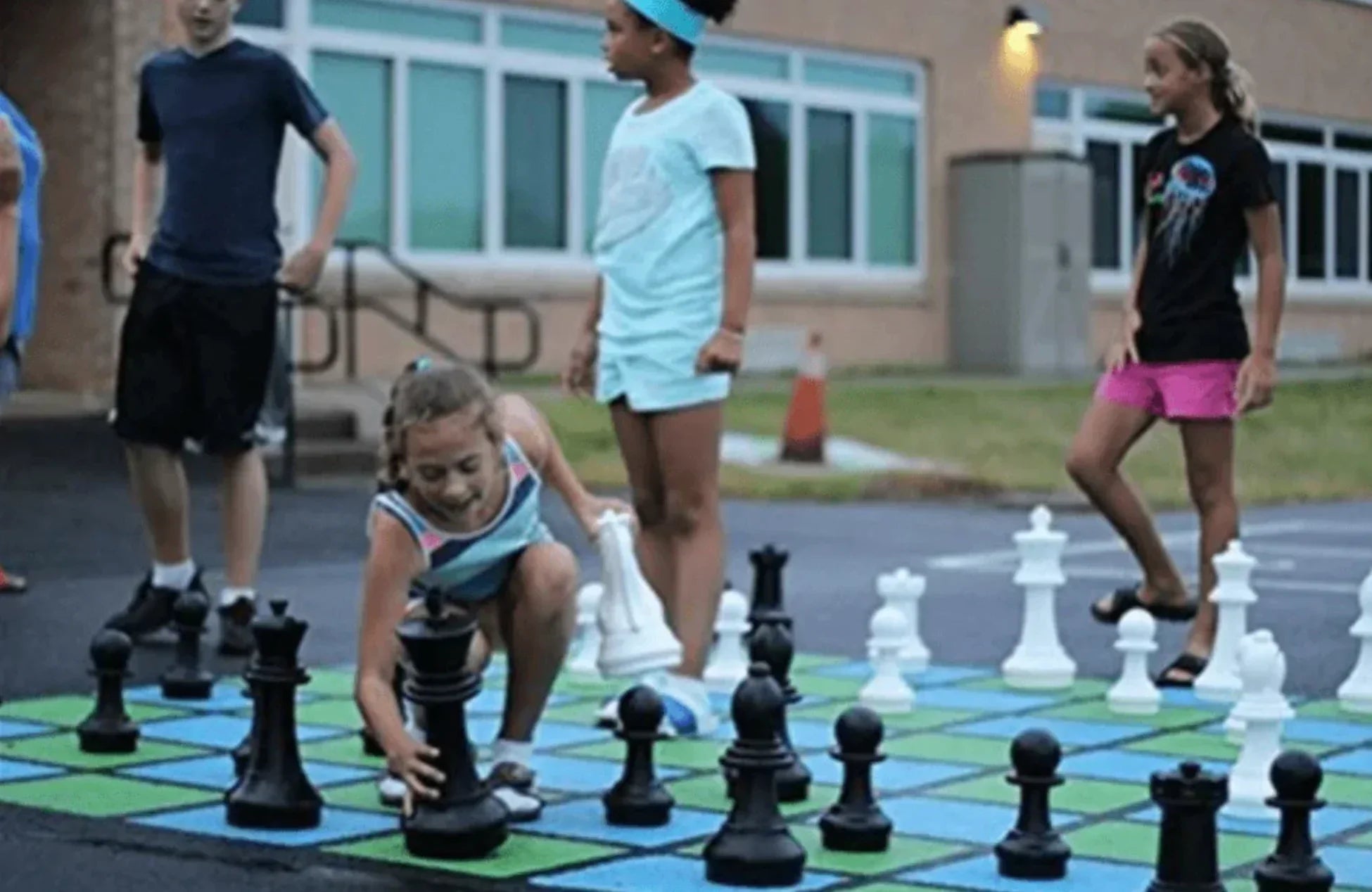 Photo children playing giant chess back to school activities for elementary students