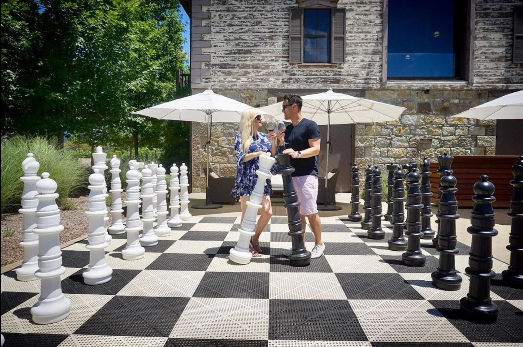 couple moving giant chess pieces showing how to improve guest experience in hotel