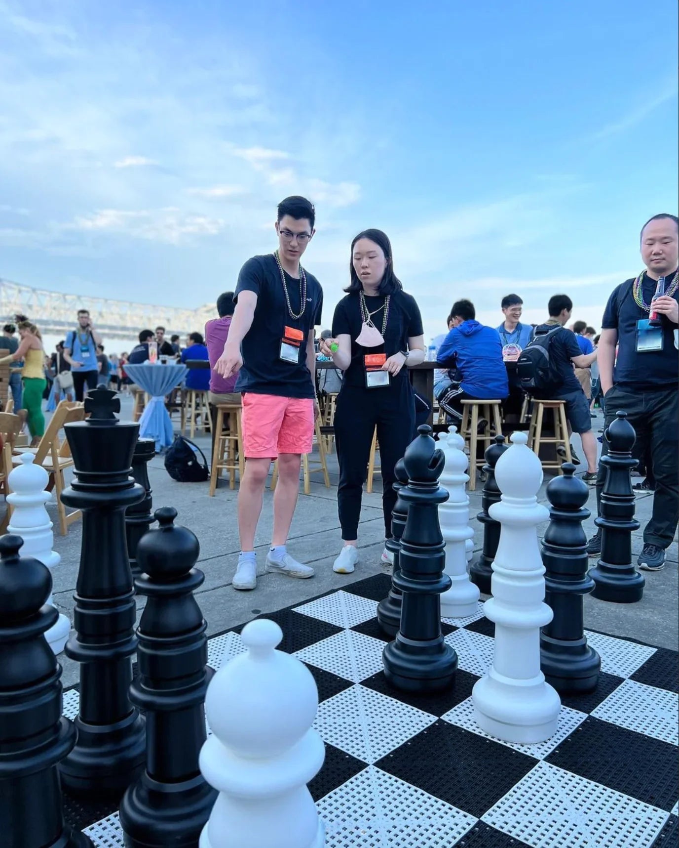 man pointing at mega chess set