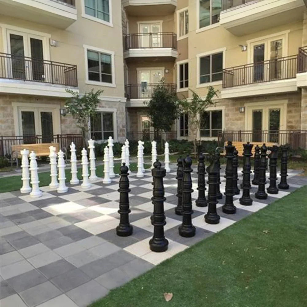 Giant Chess Sets for Your Airbnb featuring oversized black and white chess pieces in an outdoor setting.