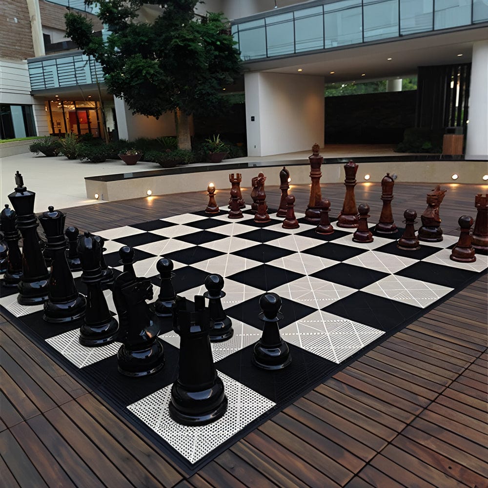Four Foot Tall Teak Giant Chess Sets displayed outdoors on a large chessboard with a modern backdrop.