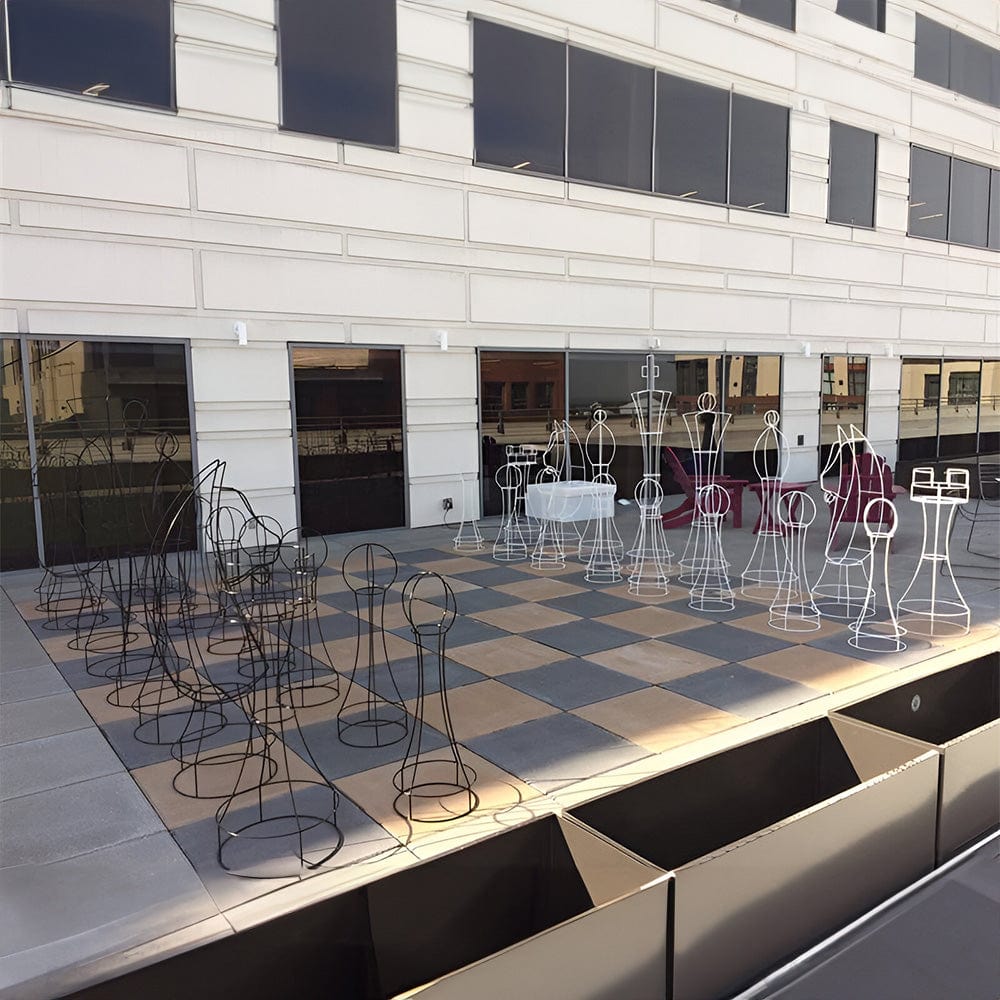 Six Foot Tall Wire Frame/Topiary Giant Chess Sets displayed outdoors in a modern setting with a large chessboard.