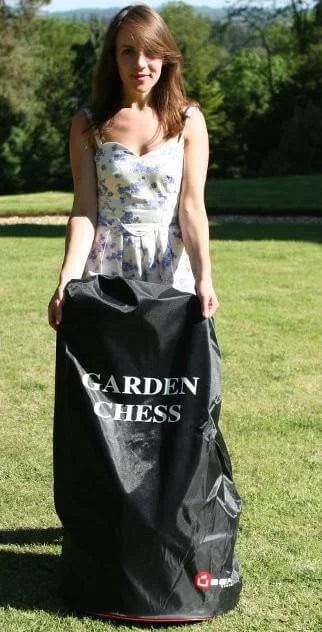 woman holding a bag for giant chess piece storage