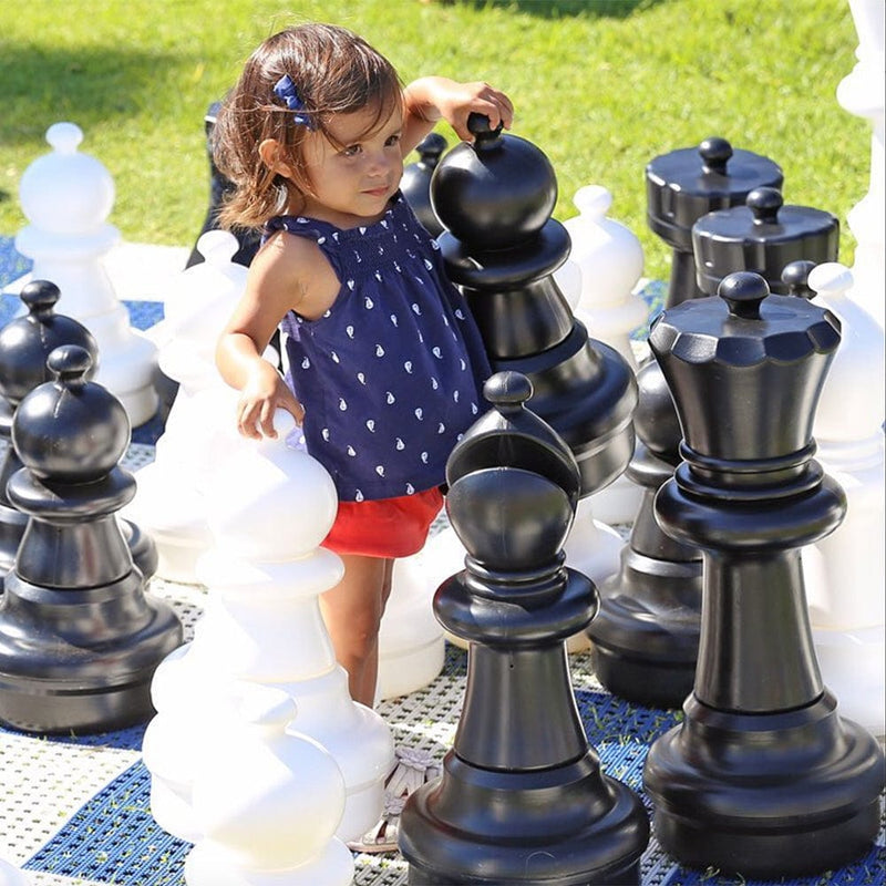 Child playing with MegaChess 25 Inch Plastic Giant Chess Set 