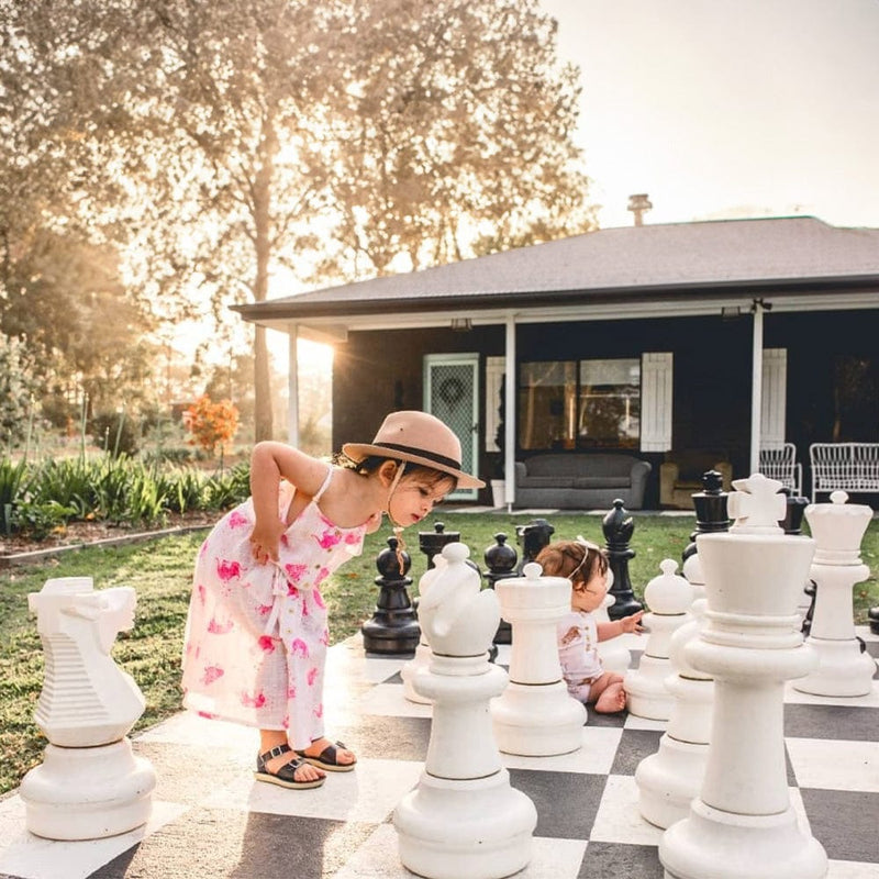Kids Looking closely at MegaChess 25" Giant Plastic Chess Set